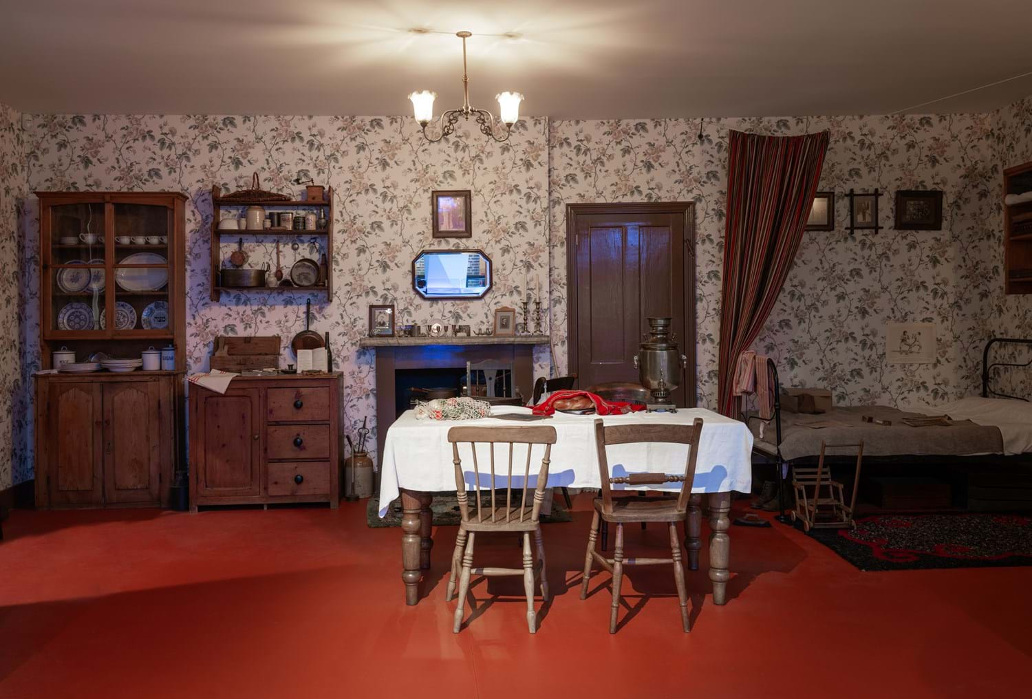 A wide shot of A Tenement Flat in 1913. It is of a scenario of the Delinsky family home on a Friday night welcoming in Shabbos.