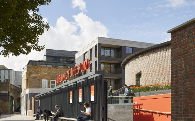 Exterior of the Museum with a gate and orange walls, trees and blue skies