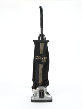 Black Hoover upright vacuum cleaner with fabric dust bag and chrome base