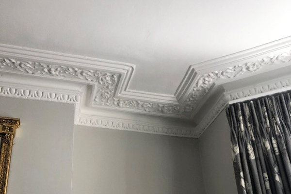 Ornate white crown molding and decorative ceiling trim.