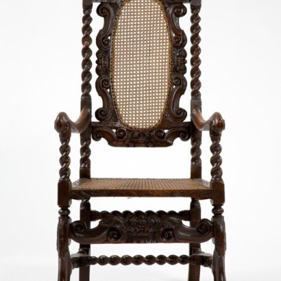 Chair with twisted posts, carved decoration, and cane seat and back.