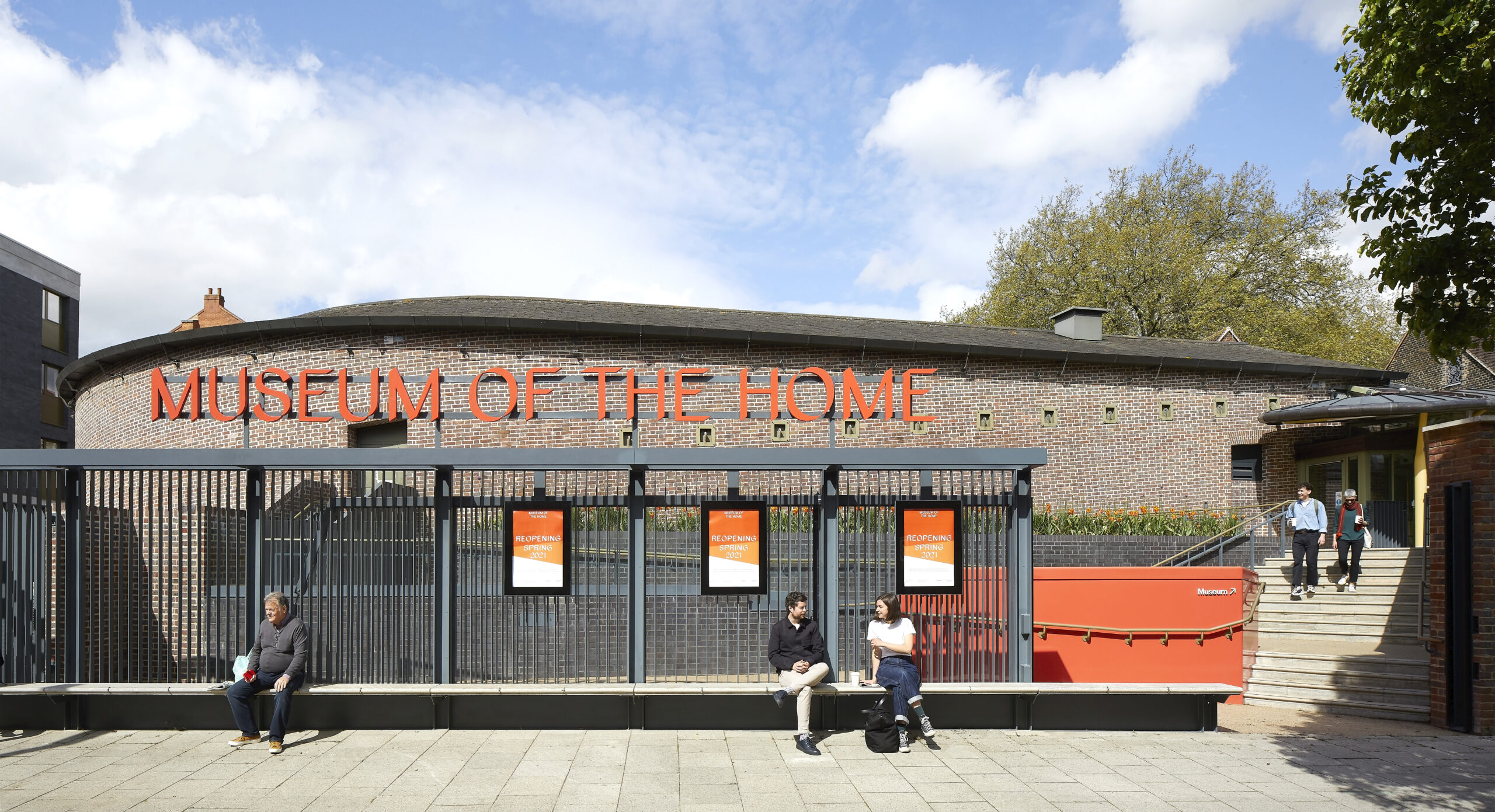 A head-on view of the main entrance to the Museum, featuring a red-brick terrace façade and modern glass extension from the recent redevelopment by Wright+Wright.