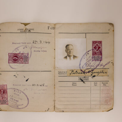 A identification document showing renewal stamps and a black and white photograph of a man. The text 'Patrick O'Loughlin' is readable.