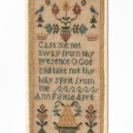 Rectangular embroidered sampler on beige fabric, featuring a central cross-stitched prayer: “Cast me not away from thy presence O God and take not thy holy spirit from me. Ann Fifield April". Above the text are four flowers in symmetry sided by blue birds and small trees; below are two flowering urns and a basket full of fruit.
