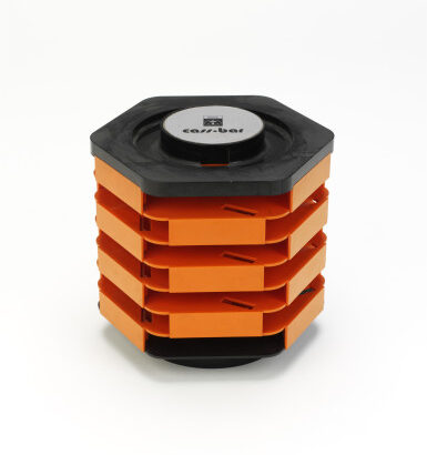 Rotating cassette holder on a white background: black hexagonal top and base sandwich five stacked bright-orange sliding trays, with “cass-bar” written in black on a white circular label centered on the top.