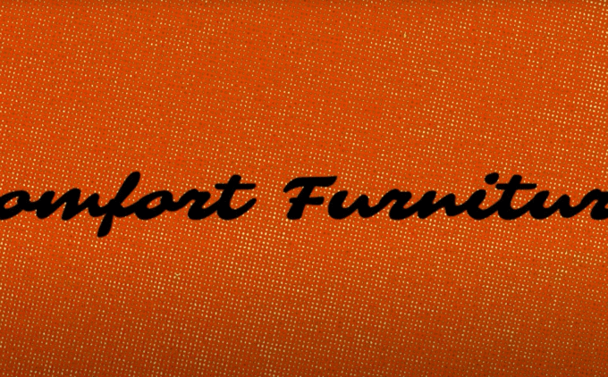 The words 'comfort furniture' in handwriting, on a background of woven orange upholstery.