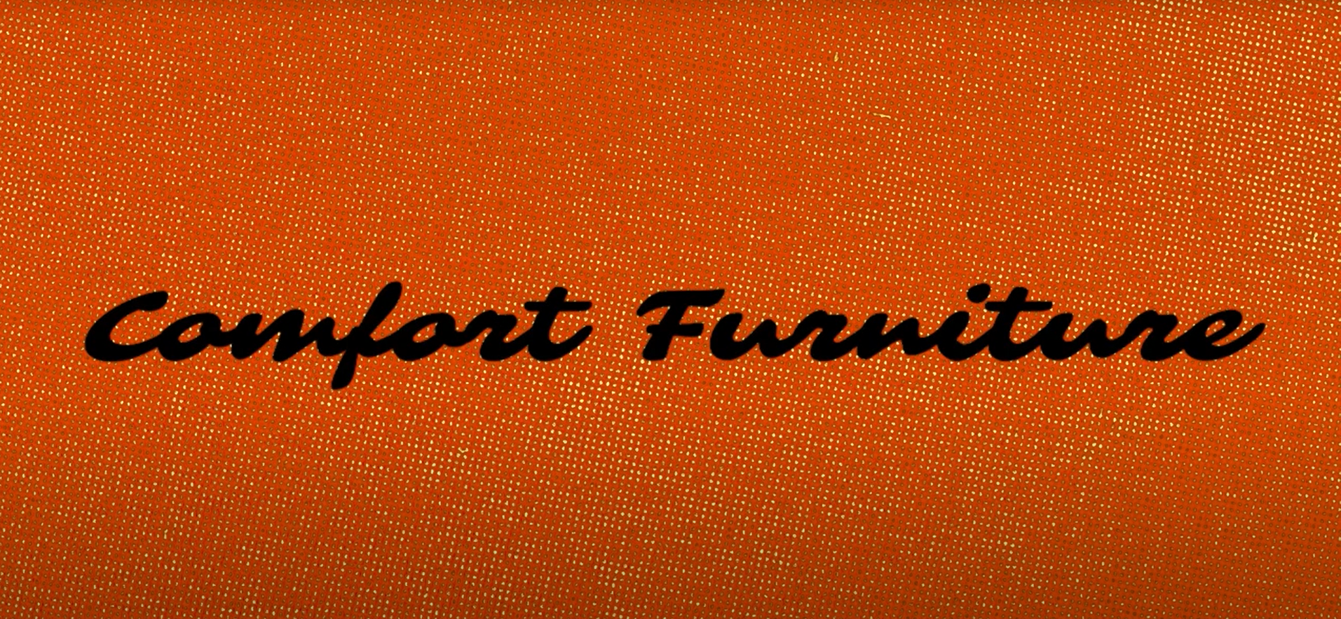 The words 'comfort furniture' in handwriting, on a background of woven orange upholstery.