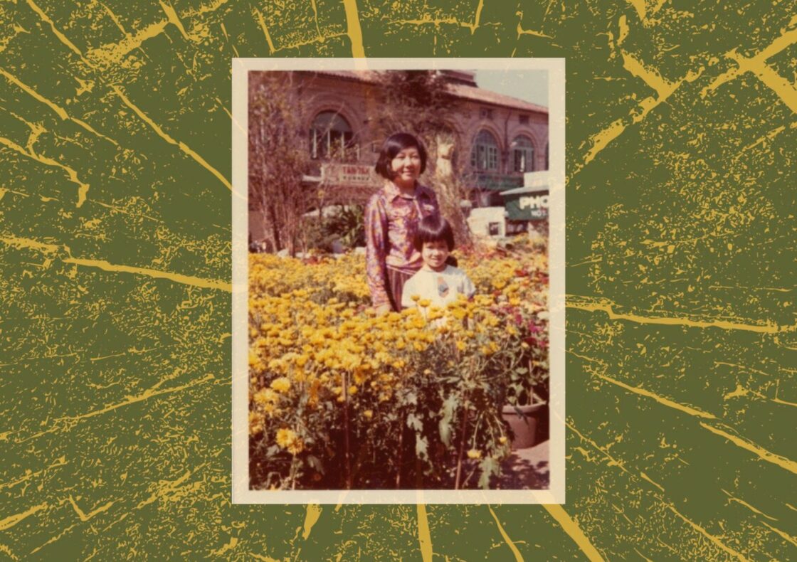An old photograph of an woman and child standing among yellow flowers. The photo is surrounded by a yellow and green artistic tree-like pattern.