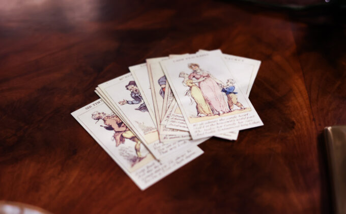 A deck of cards with illustrations of various customes.
