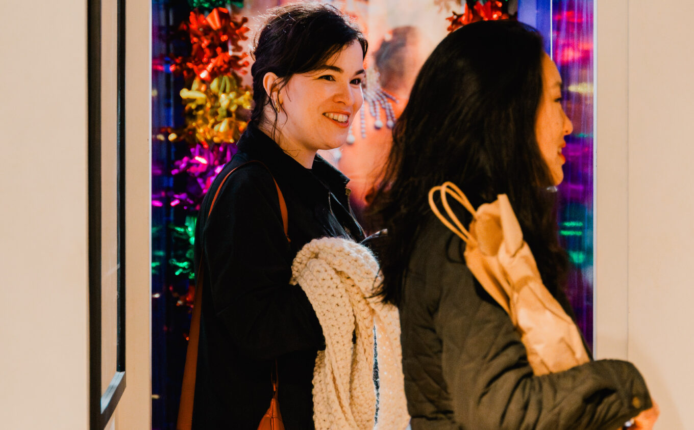 Two people smiling in a room with christmas decorations