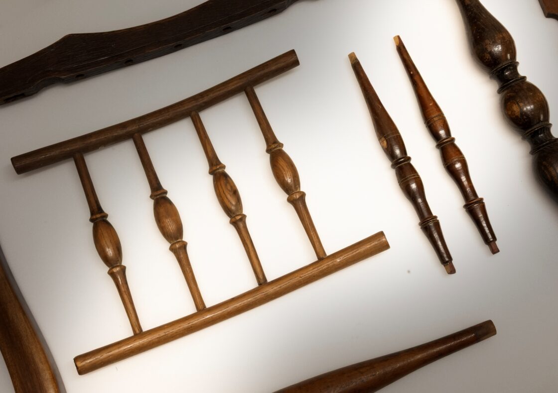 A close up of various chair spindles on a white background.