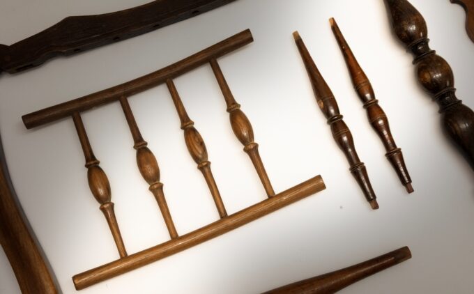 A close up of various chair spindles on a white background.