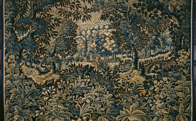 An embroidered tapestry depicting a landscape of detailed plants and foliage in hues of gold, cream and teal.
