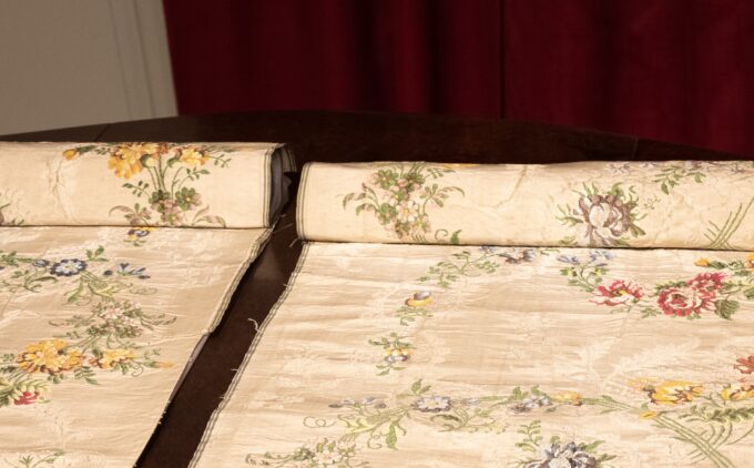 A close up of Huguenot silk rolled out on a table.