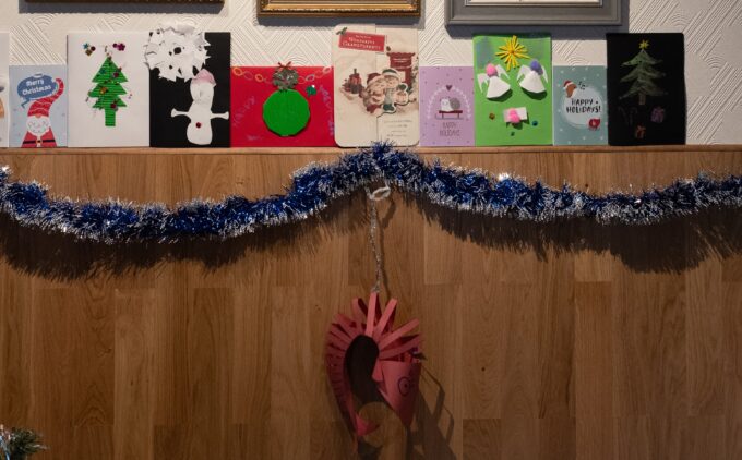 Christmas decorations in a British Vietnamese living room with Tết envelopes, Christmas lights, and more.